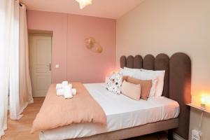a bedroom with a large bed with pink walls at Tèrra d'Automne by Rahault ConciergerieDameCarcas in Carcassonne