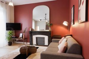 a living room with a couch and a fireplace at Tèrra d'Automne by Rahault ConciergerieDameCarcas in Carcassonne +2 photos