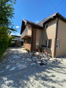 a house with a balcony and a patio at Home DINA in Ilidža