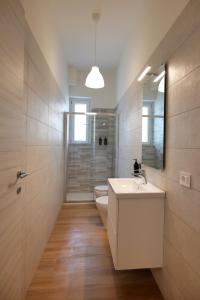 a bathroom with a white sink and a toilet at Costa d'Amalfi Apartments in Pontecagnano