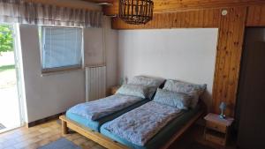 a bedroom with a bed in a room with a window at Sobe Godina in Materija +19 photos