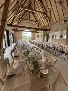 a long table in a room with tables and chairs at Hove Ter Hille in Jabbeke
