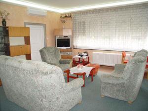 a living room with two chairs and a table at Holiday home in Balatonszarszo 48120 in Balatonszárszó