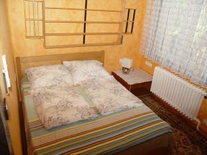a small bedroom with a bed and a window at Holiday home in Balatonszarszo 48120 in Balatonszárszó