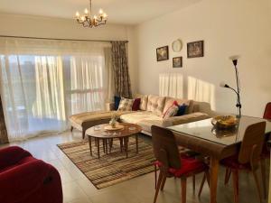 a living room with a couch and a table at Chalet ground floor 3BR amwaj sidi abdelrahman in El Alamein