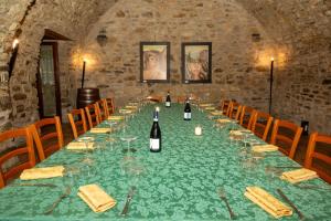 a long table with wine bottles and glasses on it at Basilicata Foresteria di San Leo Villa Esclusiva con Piscina in Trivigno +29 photos
