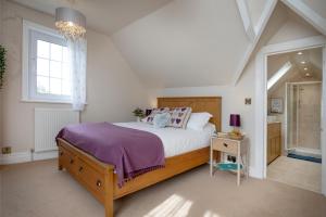 a bedroom with a large bed and a window at Budleigh Breeze in Budleigh Salterton