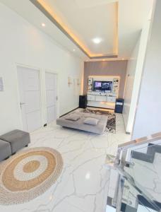 a large living room with a couch and a television at Oemah Sawah99 in Batu +1 photo