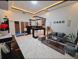 a living room with a couch and a table at Oemah Sawah99 in Batu
