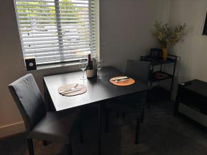 a dining room table with two plates and wine glasses at Boutique 2 bedroom apartment in Mersham +14 photos