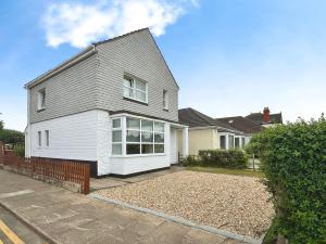 a white house with a gray roof at Cleethorpes Modern Home in Old Clee