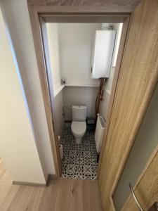 a small bathroom with a toilet in a hallway at Apartmány LISTOPAD 17 in Děčín