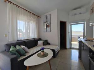 a living room with a couch and a table at Apartments Jolić in Vir