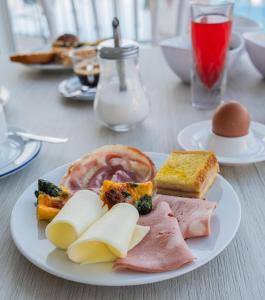 a white plate of food on a table at Hotel Ristorante Borgo La Tana in Maratea