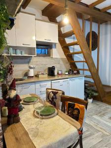 a kitchen with a table with plates on it at Cece's home in Mavrovo