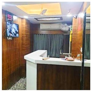 a bathroom with a sink and a mirror at Hotel Lake Palace Ahmedabad in Ahmedabad