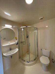 a bathroom with a shower and a toilet and a sink at Wunderland Kalkar in Kalkar