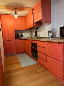 a kitchen with wooden cabinets and a sink at Roma16 in Gerola Alta