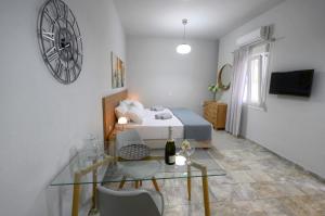 a bedroom with a bed and a glass table at Kosmas Studios in Panormos Kalymnos