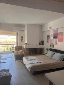 a bedroom with a bed in a room with a fireplace at Sparkling dream in Saronida
