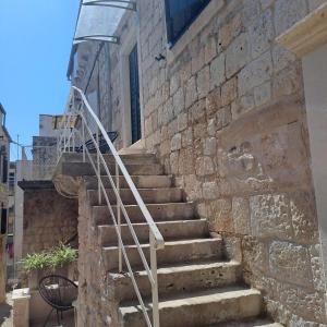 a set of stairs leading up to a brick building at Ventula in Vis