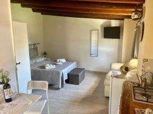 a bedroom with a bed and a table and chairs at "The Cottage"with sea view, parking & wifi in Avola