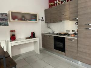 a kitchen with a sink and a stove top oven at Ciak si dorme in Marina di Massa