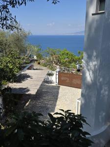 a stone walkway leading to the ocean from a house at Villa Coralia Sorrento, Luxury Suite in Amalfi Coast, Italia in Sorrento +47 photos