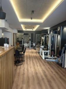 a gym with chairs and a bar in a room at Apartmani prenj 1 i 2 centar in Konjic