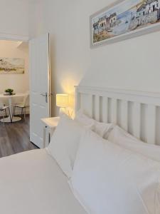 a bedroom with two white beds and a table at Euston Road - Beach Apartment 8 in Great Yarmouth