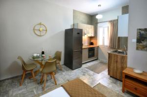 a kitchen with a small table and a refrigerator at Kosmas Studios in Panormos Kalymnos