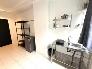 a small kitchen with a sink and a refrigerator at Patong Canal Villa R105 in Patong Beach
