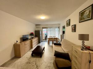 a living room with a couch and a table at Studio avec grand balcon - Roquebrune Cap-Martin proche Menton et Monaco in Roquebrune-Cap-Martin