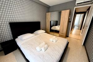 a bedroom with a bed with three pillows on it at Antibes hyper center - 4 people - close to shops and beaches in Antibes +5 photos