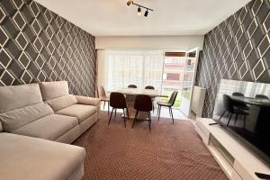 a living room with a couch and a table and chairs at Antibes hyper center - 4 people - close to shops and beaches in Antibes