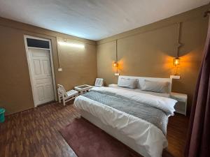 马拉里The Gooodmen cafe and Lodge的一间卧室设有一张大床和一扇门