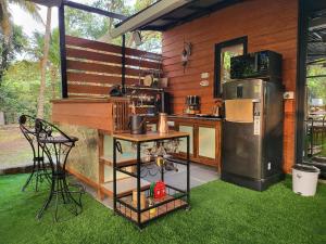 a kitchen with a counter and a refrigerator and grass at Bombay High Retreat in Parhūr