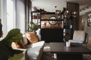 a living room with a couch and a table at Home Hotel Etage in Västerås