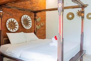 Postel nebo postele na pokoji v ubytování Bramasa Ubud Guest House