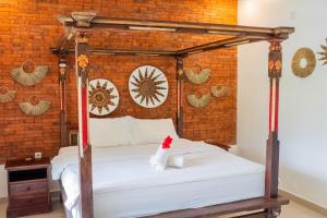 Postel nebo postele na pokoji v ubytování Bramasa Ubud Guest House