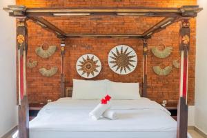 Postel nebo postele na pokoji v ubytování Bramasa Ubud Guest House