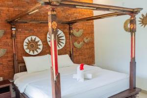 Postel nebo postele na pokoji v ubytování Bramasa Ubud Guest House