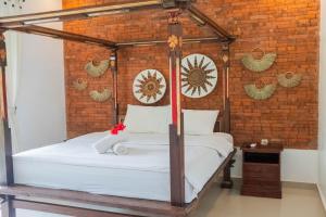Postel nebo postele na pokoji v ubytování Bramasa Ubud Guest House