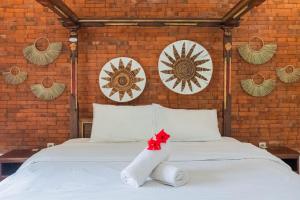 Postel nebo postele na pokoji v ubytování Bramasa Ubud Guest House