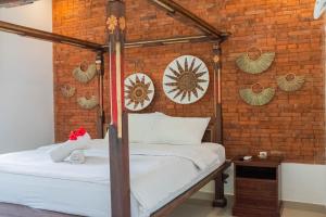 Postel nebo postele na pokoji v ubytování Bramasa Ubud Guest House
