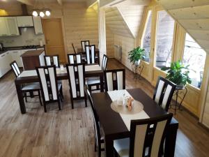 a restaurant with tables and chairs in a room at Noclegi Pod Tatrami przy Termach in Witów