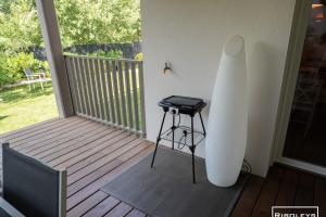a white surfboard sitting on a porch with a table at Superbe T3 climatisé avec WIFI à 400m de la plage in Vias