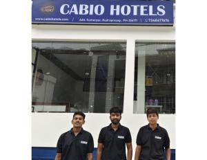a group of men standing in front of a building at casbio hotels in Rudraprayāg