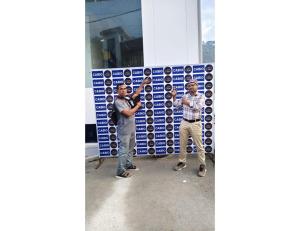 three men standing in front of a wall of glasses at casbio hotels in Rudraprayāg