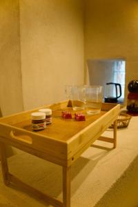 a wooden table with glasses and jars on it at Love Room du Château Fort - Jacuzzi & Insolite ! in Mercury +34 photos